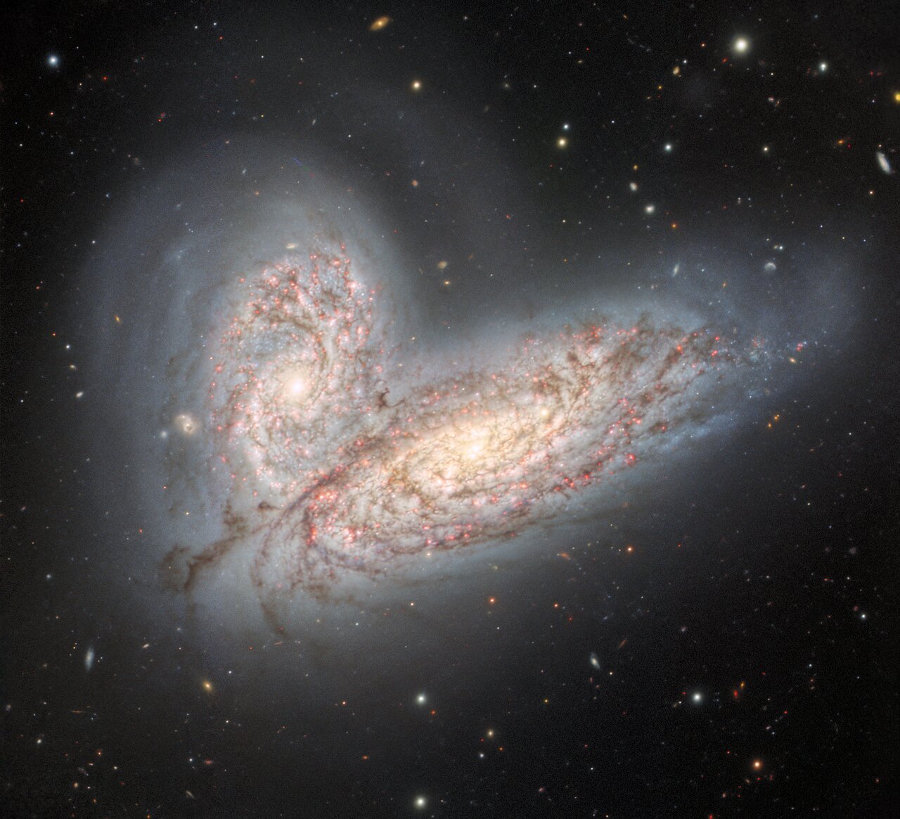 two colliding galaxies are merging to look like a pair of butterfly wings.