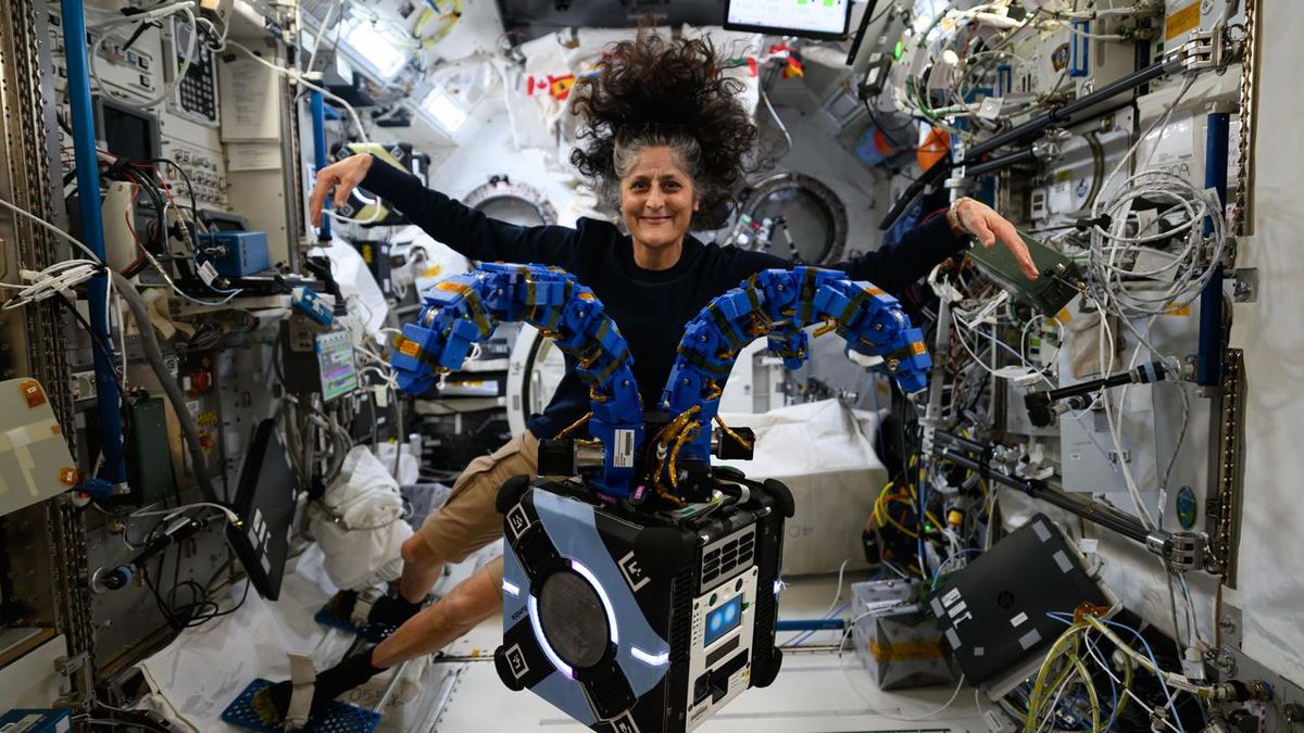 NASA astronaut Suni Williams poses with pretty tentacle-armed Astrobee robotic on ISS ({photograph})